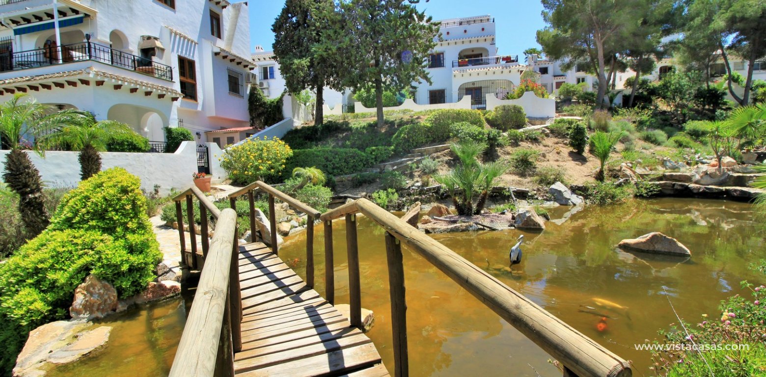 South-Facing Lola Bungalow For Sale in Verdemar III Villamartin communal gardens pond
